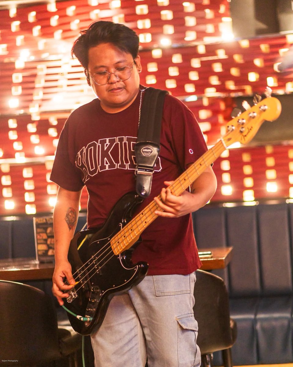 Bass in front of the red light wall